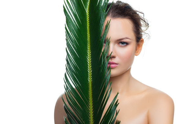 Woman with palm leaf. - Valokuva, kuva