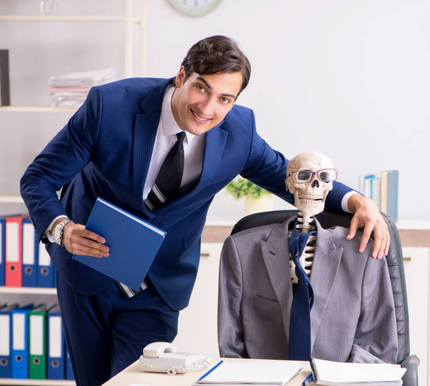 A reunião de negócios engraçada com chefe e esqueletos
 - Foto, Imagem