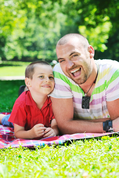 Happy father and son have fun at park - Фото, изображение