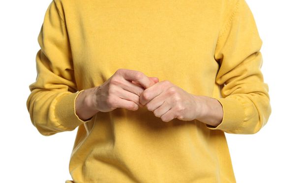 Woman cracking her knuckles on white background, closeup. Bad habit - Φωτογραφία, εικόνα