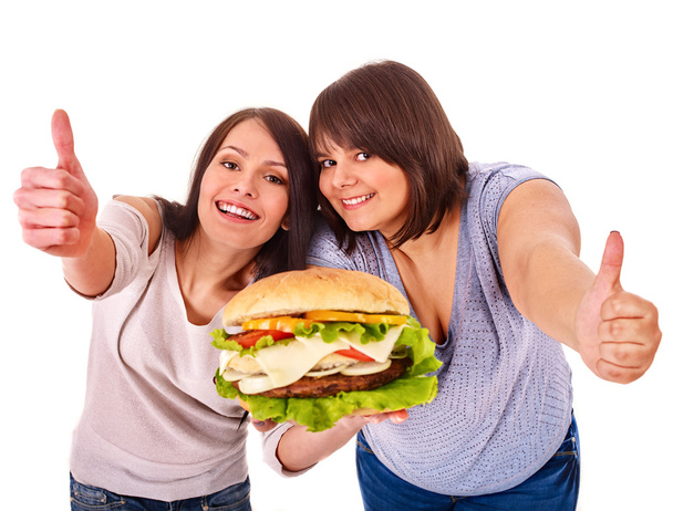 vrouwen hamburger eten. - Foto, afbeelding