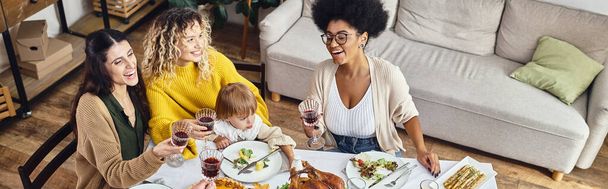 Happy Thanksgiving, joyful multiethnic women and baby girl having a good time together, banner - Photo, Image