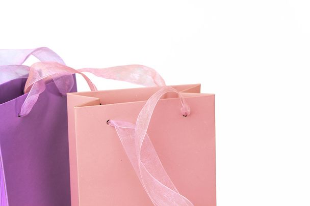 Pastel pink and lilac colorful shopping bags tops closeup isolated - Fotó, kép