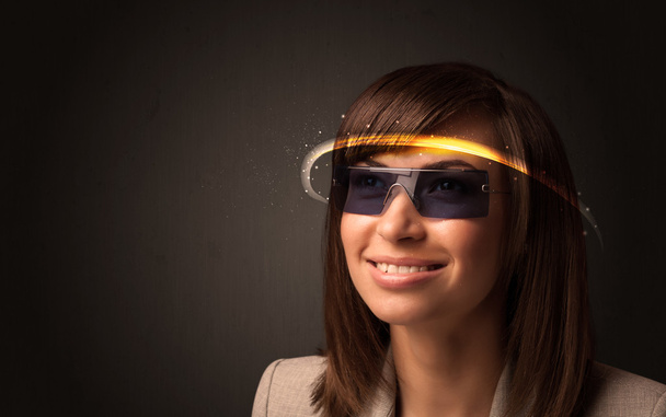 Pretty woman looking with futuristic high tech glasses  - Photo, image