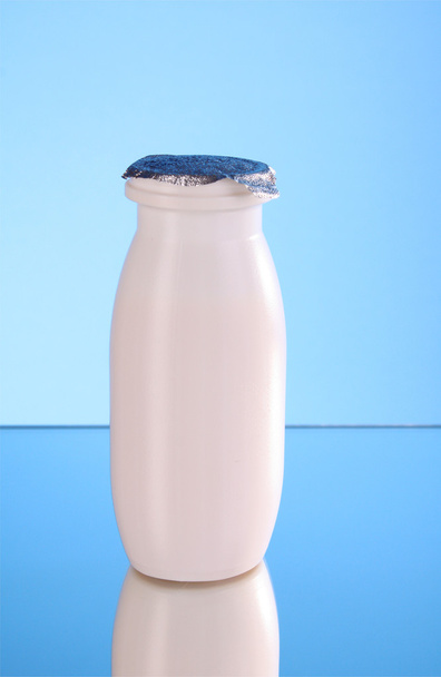 Bottle of milk on blue background - Zdjęcie, obraz