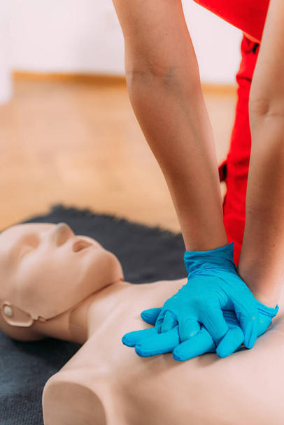 CPR Training Course. Chest compression techniques in a CPR first aid training with a dummy. - Photo, Image