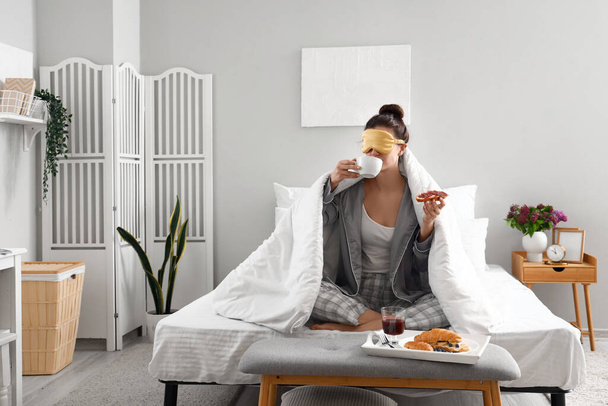 Morning of young woman having breakfast in bedroom - Photo, Image