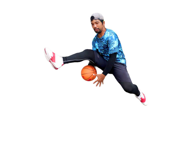 ボールを保持し,クリッピングパスでジャンプするバスケットボール選手 - 写真・画像