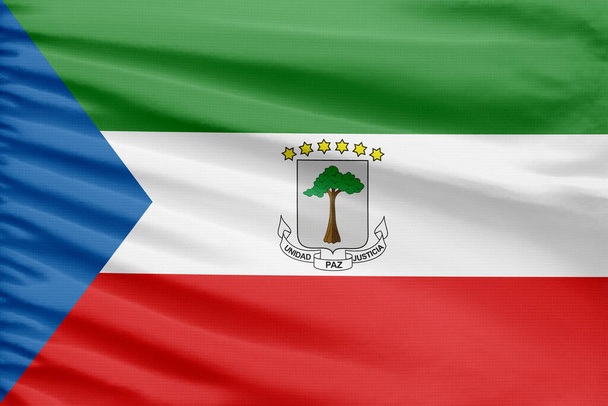 Bandera de Guinea Ecuatorial se representa en un tejido de punto deportivo con pliegues. - Foto, Imagen