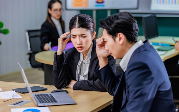 Millennial Asian stressed depressed worried thoughtful professional male businessman female businesswoman employee staff in formal business suit sitting thinking solving problem ideas in office room. - Photo, Image