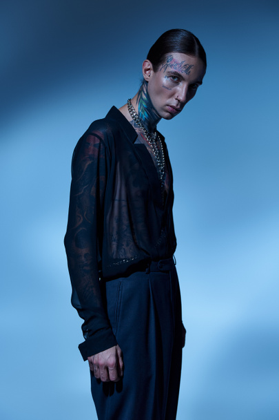 good looking young man in stylish transparent shirt with tattoos looking at camera, fashion concept - Foto, afbeelding