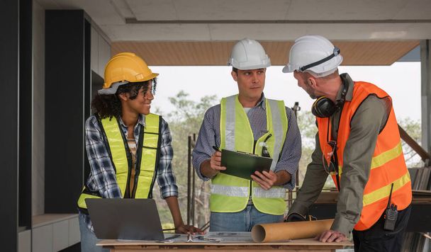 Diverse Team of Specialists Use Laptop on Construction Site. Real Estate Building Project with Engineer Investor and Businessman Checking Area, working on Civil Engineering, Discussing Strategy Plan. - Photo, image