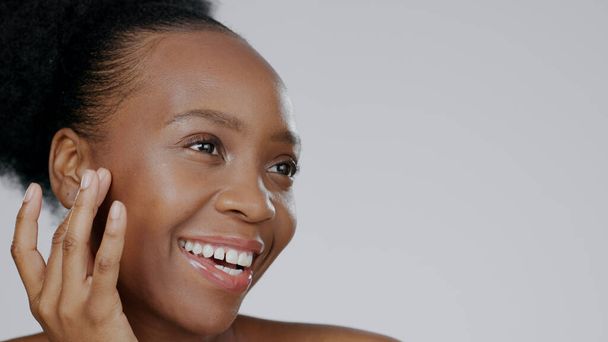 Black woman, face and natural beauty with skincare, facial with cosmetic care and skin glow on white background. Mockup space, dermatology and African model smile, moisturizer and treatment in studio. - Photo, Image