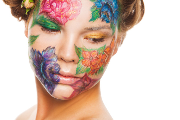 Close up portrait of woman model with hand drawing flowers on her face - Foto, afbeelding