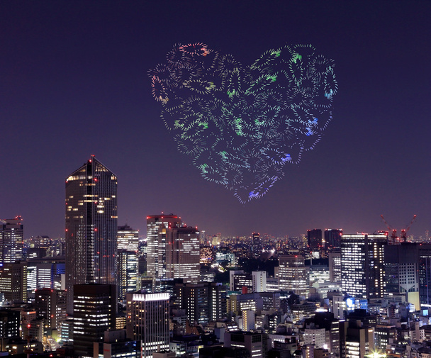 heart sparkle Fireworks celebrating over Tokyo cityscape at nigh - Photo, Image