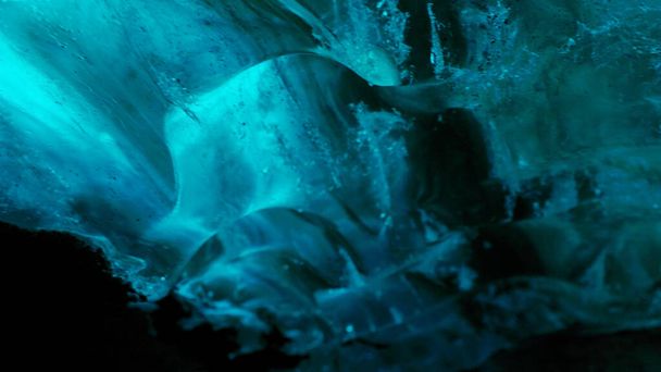 Vatnajokull glacier hiking in crevasse, nordic landscape inside ice cave with blue ice rocks. Frosty polar icebergs with cracked frozen structure, icelandic freezing cold destination . Handheld shot. - Photo, Image