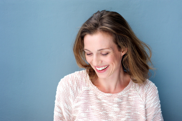 Beautiful mid adult woman laughing with sweater - Photo, Image