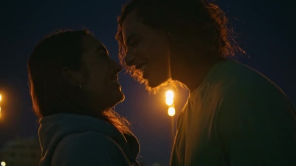 Romantic teens face enjoy love standing night sky background closeup. Smiling relaxed pair touching noses having fun at evening place. Young loving couple feeling closeness flirting at romantic date - Footage, Video