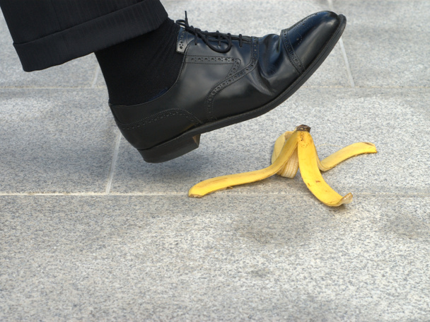 Businessman about to step on a banana skin - Photo, Image