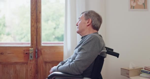 Elderly man, wheelchair and retirement with thinking of life, sadness and lonely. Nursing home, senior and person with disability in pain, arthritis and grief in memory loss, anxiety and isolated. - Footage, Video