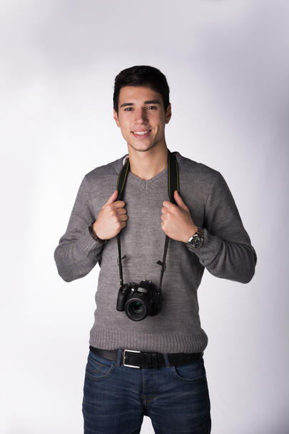 Handsome man with professional photo camera - Foto, imagen