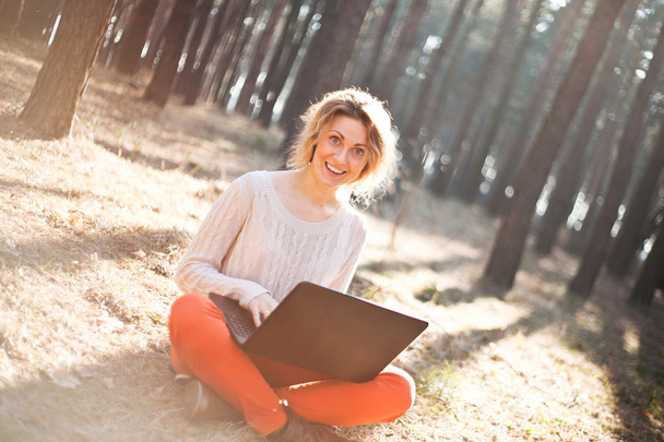 mosolygó fiatal lány laptop a szabadban - Fotó, kép