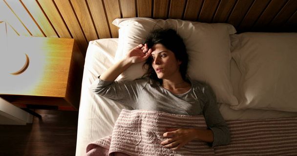 Anxious single woman in bed suffering before sleep - Foto, Imagem
