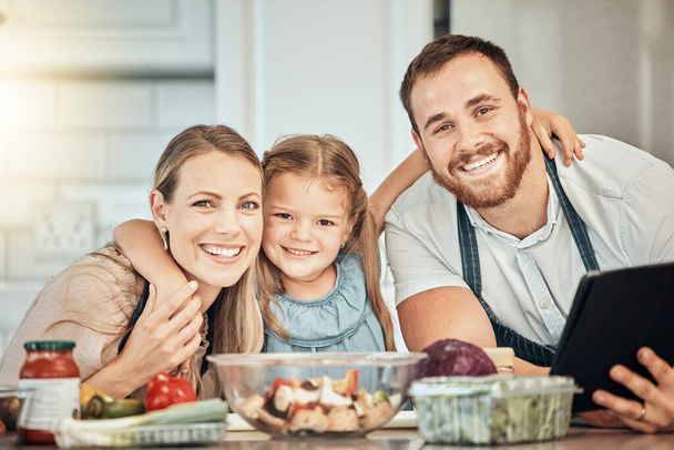 Portrait of happy family in kitchen, cooking with kid and smile, learning and nutrition with parents smile. Mom, dad and girl child making healthy food in home with care, support and love at lunch - Foto, afbeelding