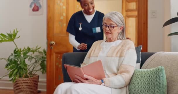 Tablet, caregiver and senior woman on sofa browsing on internet for medical consultation research. Happy, healthcare and African female nurse talk to elderly patient networking on technology at home - Footage, Video