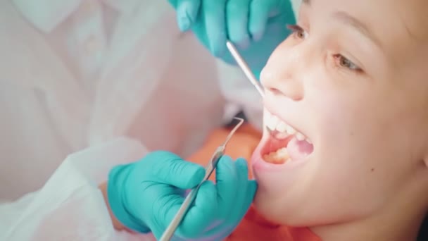 mentse egészségét fogak gyermekek, tini lány fogorvoshoz, orvos megvizsgálja a fogát, gyógyítására fogszuvasodás és pulpitis, egészségügyi és egészségügyi biztosítás - Felvétel, videó