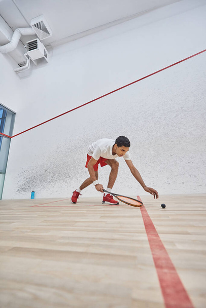 active african american sportsman playing squash inside of court, challenge and motivation - 写真・画像