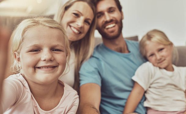 Selfie, happy family and parents with kids on social media picture by living room couch together in the morning. Love, care and mother bonding with father and children with memory online with smile. - Photo, Image