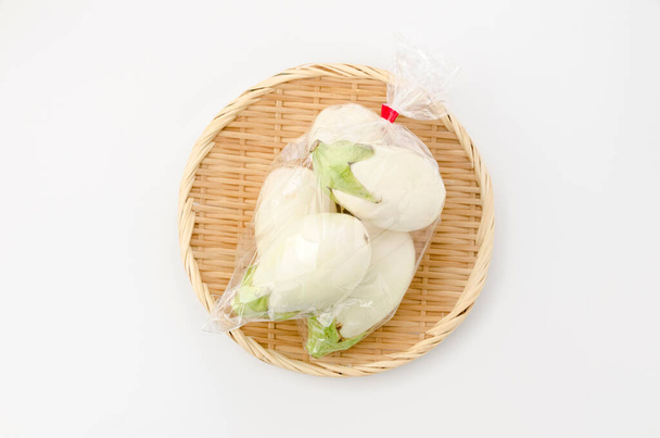 White eggplant in Plastic bag on bamboo sieve on white background - Photo, Image