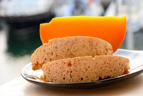 Pieces of native French aged cheese Mimolette, produced in Lille with greyish curst made by special cheese mites close-up - Photo, Image