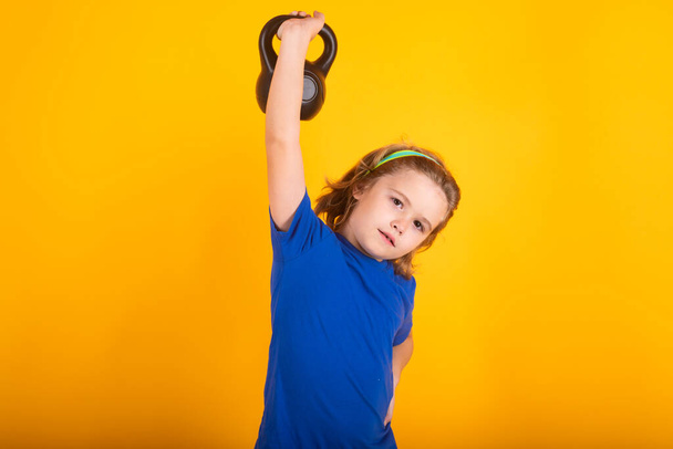 Kid boy working out with dumbbells. Sport and kids training - Photo, Image
