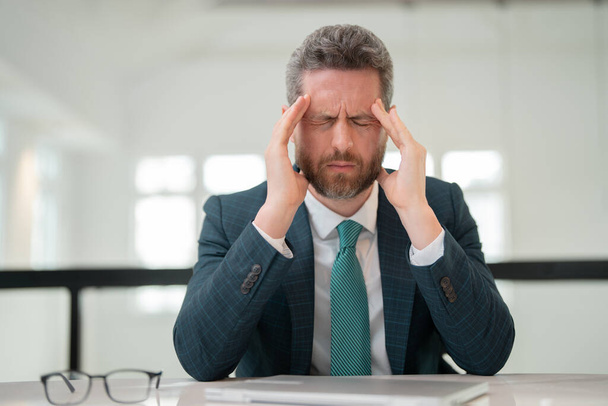 Tired, headache and eye strain from laptop. Businessman with stress, burnout and fatigue eyestrain. Business man rubbing tired eyes after computer work - Photo, Image