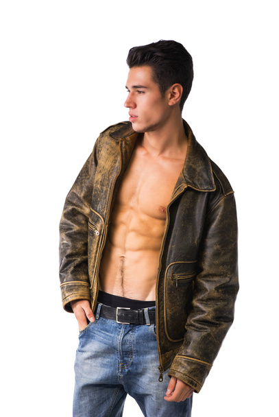 Handsome young man wearing leather jacket on naked torso - Фото, изображение