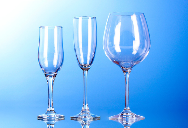 Few empty wine glasses on blue background - Foto, Bild
