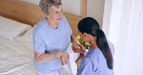 Old woman, bed or caregiver helping in nursing home, retirement clinic for wellness or support. People, nurse or elderly patient holding hands with doctor or social worker for injury rehabilitation. - Footage, Video