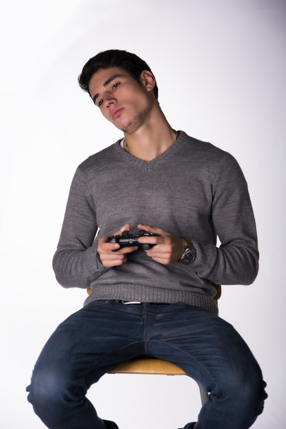 Young man using joystick or joypad for videogames - Фото, изображение