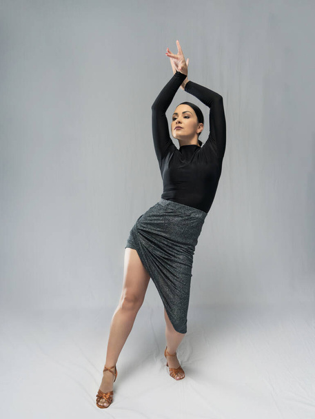 Woman dancer in a gray outfit on a white background - Photo, Image