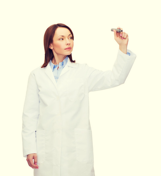 young female doctor writing something in the air - Photo, image
