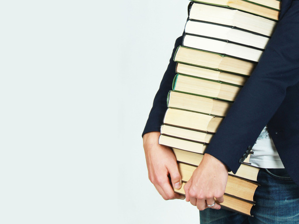 Man holding a stack of books - Foto, imagen