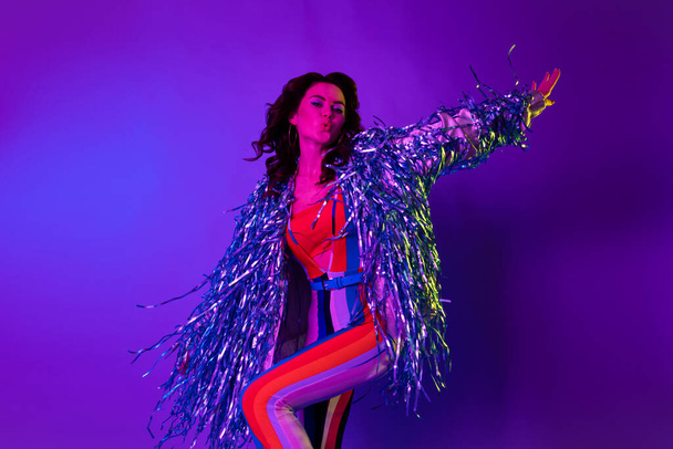 Photo of shiny dreamy girl dressed glitter jacket dancing oldschool discotheque isolated gradient violet color background. - 写真・画像