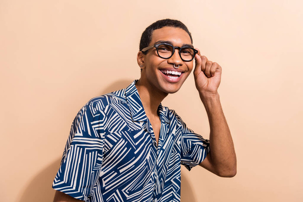 Photo of optimistic cool guy dressed trendy print outfit wear stylish glasses isolated on beige color background. - Zdjęcie, obraz