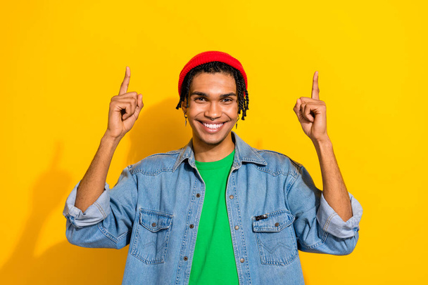 Photo of cheerful satisfied man wear stylish clothes two arms demonstrating empty space novelty offer isolated on yellow color background. - Zdjęcie, obraz