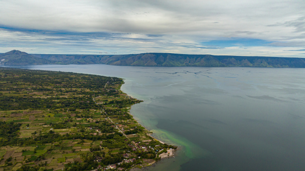 Aerial drone of Lake Toba on the island of Sumatra in Indonesia, is the largest volcanic lake in the world. Samosir island. - Photo, Image