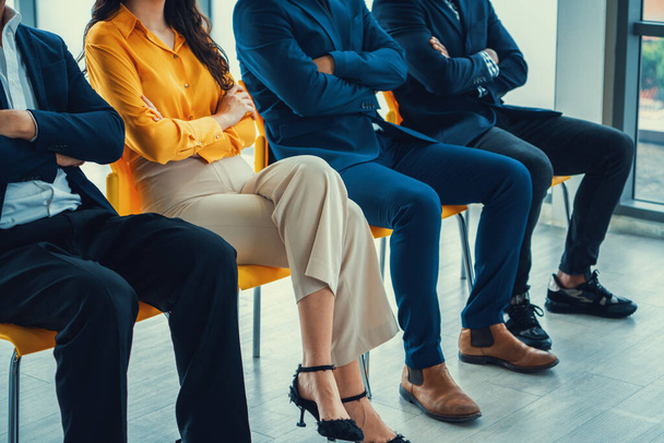 Diversity candidates siting while waiting for job interview with arm crossed in side view. Low section cropped image of business people smiling with confident. Modern waiting room. Intellectual. - Photo, Image