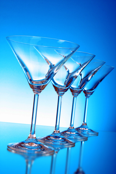 Empty glasses of martini on the light blue background - Foto, Bild