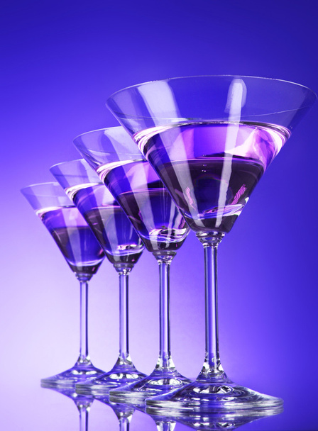 Four martini glasses on blue background - Foto, Imagem